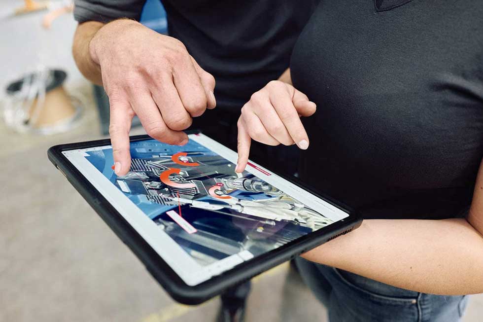 Mitarbeitender überprüft Maschinen im Rahmen einer geplanten Instandhaltungsstrategie zur Vermeidung von Ausfällen